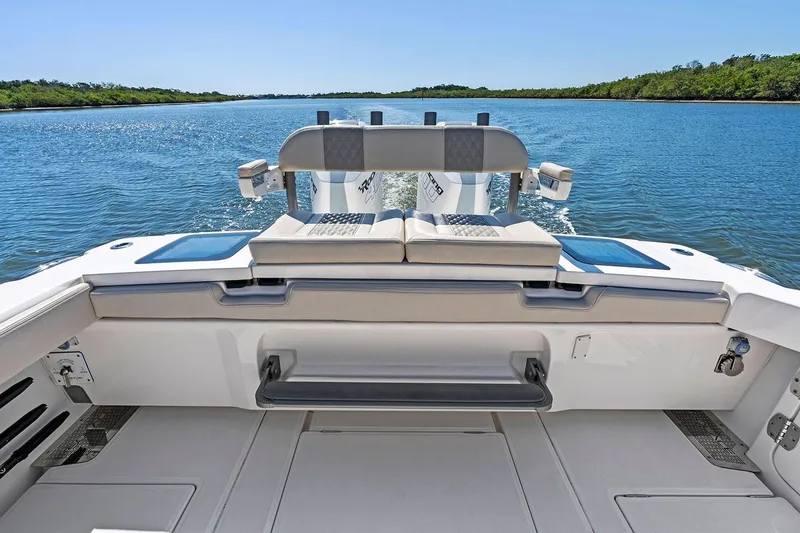 Slide: The Image of Manufacturer Provided Image: 2026 Solace 32 CS boat interior with seating, on a serene waterway. - 10