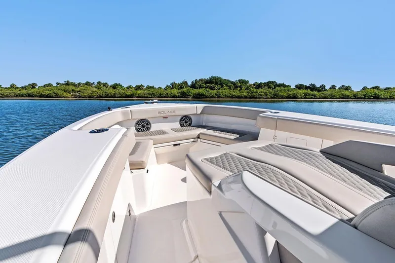 Slide: The Image of Manufacturer Provided Image: Luxurious 2026 Solace 32 CS boat interior with plush seating on a serene waterway. - 4