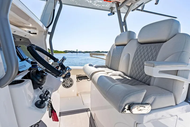 Slide: The Image of Manufacturer Provided Image: Luxurious interior of 2026 Solace 32 CS boat with plush seating and modern steering. - 7