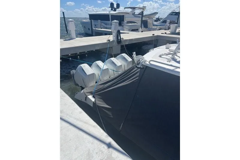 Slide: The Image of 2018 Everglades 435 Center Console boat docked with covered engines. - 14