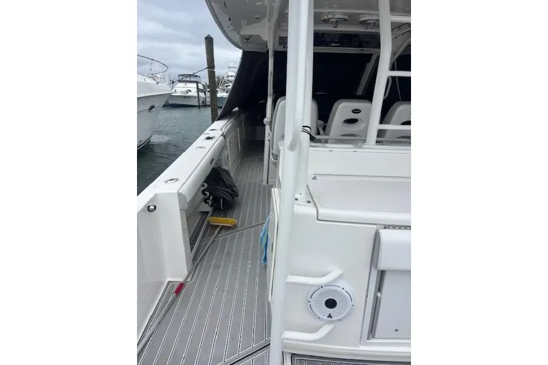 Slide: The Image of 2018 Everglades 435 Center Console boat docked, showcasing sleek design and spacious deck. - 29