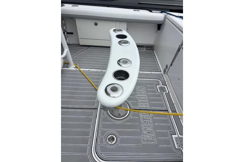 Slide: The Image of 2018 Everglades 435 Center Console boat deck with rod holders and branded flooring. - 32