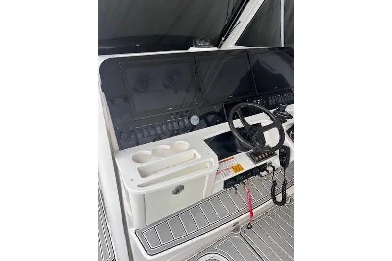 Slide: The Image of 2018 Everglades 435 Center Console boat helm with steering wheel and electronic displays. - 36
