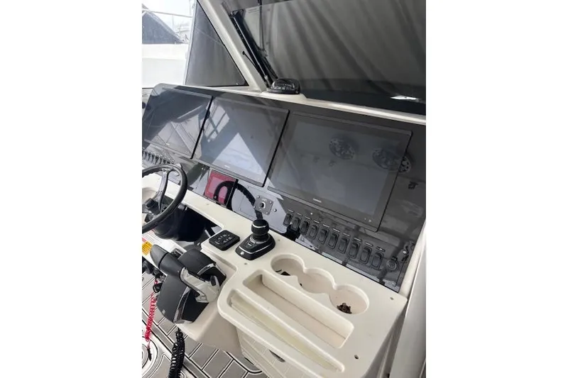 Slide: The Image of Control panel of a 2018 Everglades 435 Center Console boat with multiple screens and controls. - 37