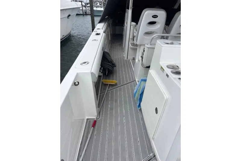 Slide: The Image of 2018 Everglades 435 Center Console boat deck with seating and storage compartments. - 41