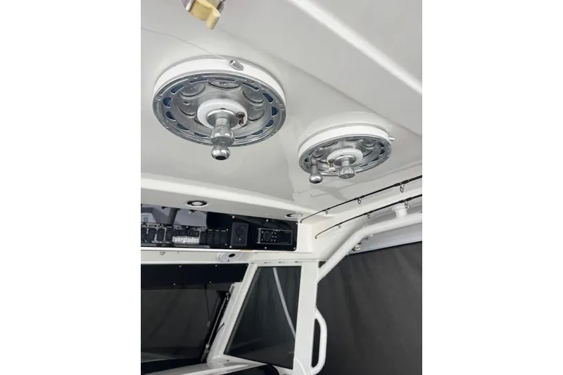 Slide: The Image of Interior view of a 2018 Everglades 435 Center Console boat, featuring ceiling-mounted speakers. - 42