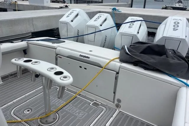 Slide: The Image of 2018 Everglades 435 Center Console boat with multiple outboard engines docked at marina. - 43