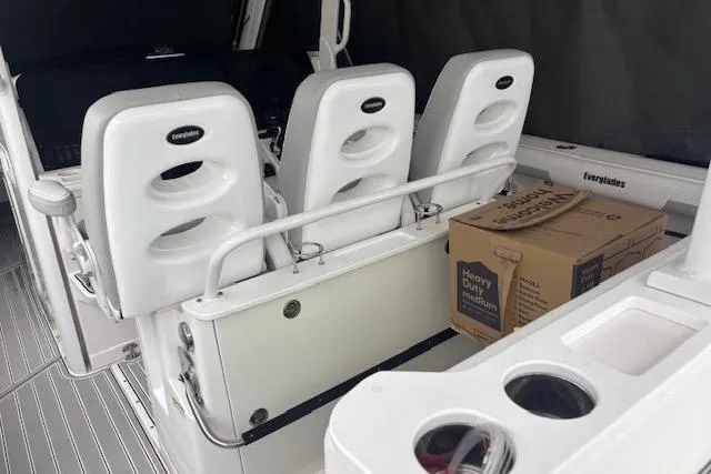 Slide: The Image of 2018 Everglades 435 Center Console boat interior with seating and storage box. - 46