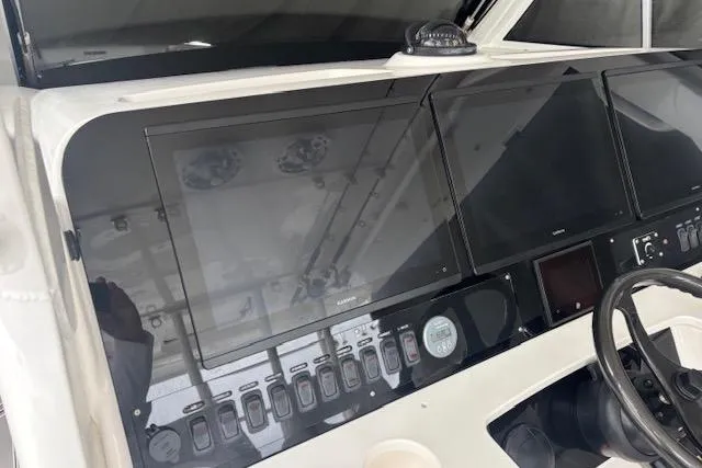Slide: The Image of 2018 Everglades 435 Center Console boat dashboard with modern navigation displays. - 50