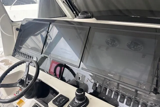 Slide: The Image of 2018 Everglades 435 Center Console helm with advanced navigation displays and controls. - 51