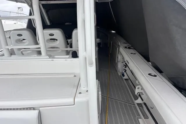 Slide: The Image of 2018 Everglades 435 Center Console boat interior with seating and storage areas. - 52