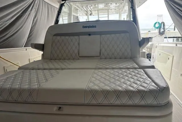 Slide: The Image of 2018 Everglades 435 Center Console boat with luxurious quilted seating in a covered area. - 57