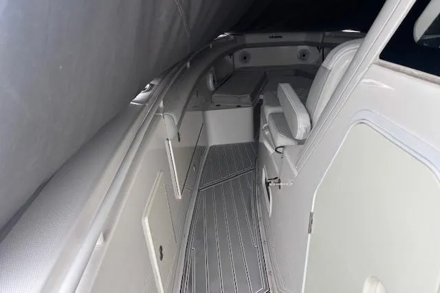 Slide: The Image of 2018 Everglades 435 Center Console boat interior with seating and storage compartments. - 59