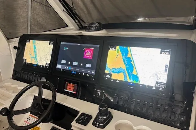 Slide: The Image of Control panel of 2018 Everglades 435 Center Console with navigation screens and steering wheel. - 61