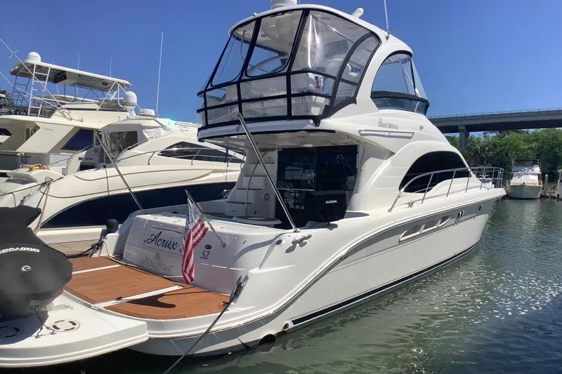 Slide: The Image of 2007 Sea Ray 52 Sedan Bridge yacht docked in marina, sunny day. - 11