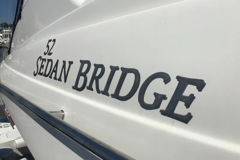 Slide: The Image of 2007 Sea Ray 52 Sedan Bridge yacht side view with model name displayed. - 12