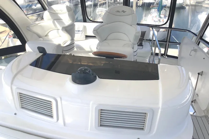 Slide: The Image of Luxurious 2007 Sea Ray 52 Sedan Bridge yacht interior with plush seating and helm controls. - 19