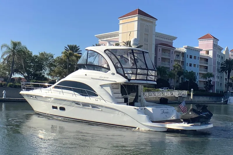 Slide: The Image of 2007 Sea Ray 52 Sedan Bridge yacht docked near waterfront buildings. - 2