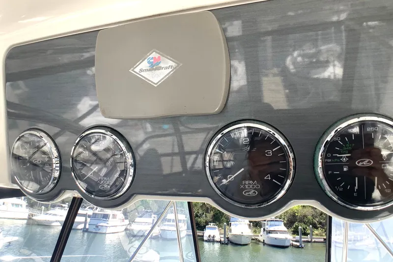 Slide: The Image of Dashboard of a 2007 Sea Ray 52 Sedan Bridge with gauges and SmartCraft logo. - 21