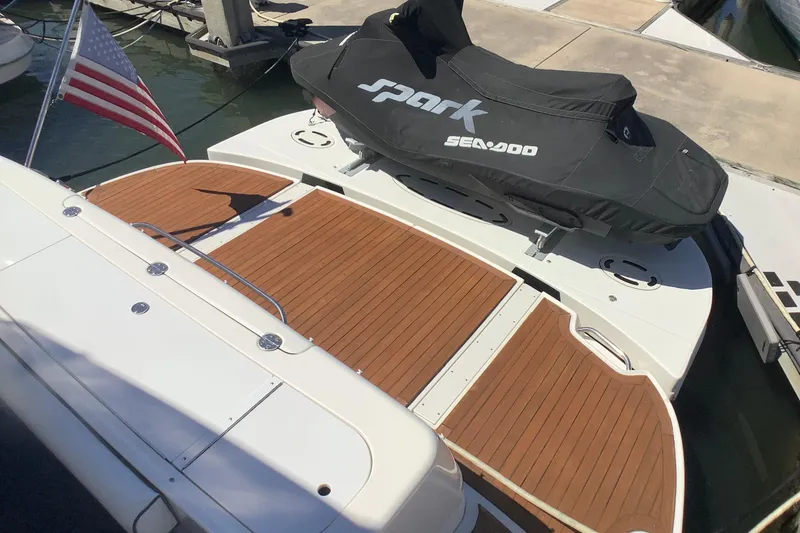 Slide: The Image of 2007 Sea Ray 52 Sedan Bridge with Sea-Doo Spark on teak swim platform. - 26
