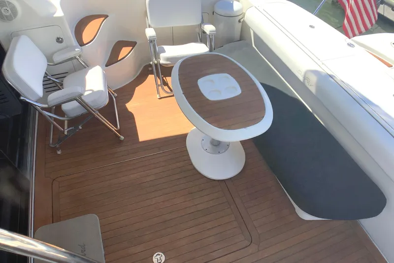 Slide: The Image of 2007 Sea Ray 52 Sedan Bridge yacht deck with seating and table. - 27