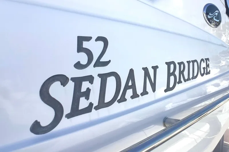 Slide: The Image of 2007 Sea Ray 52 Sedan Bridge yacht nameplate on white hull. - 28