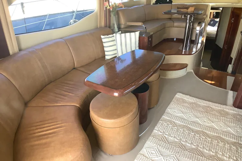 Slide: The Image of Luxurious interior of a 2007 Sea Ray 52 Sedan Bridge yacht with leather seating and wooden table. - 29