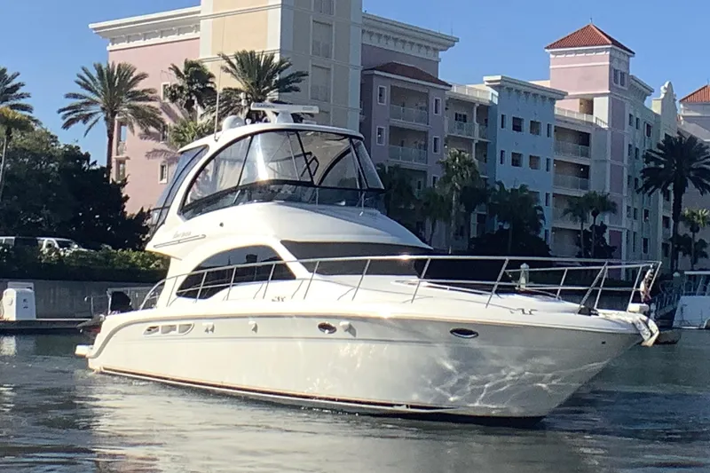 Slide: The Image of 2007 Sea Ray 52 Sedan Bridge yacht docked near waterfront buildings and palm trees. - 3