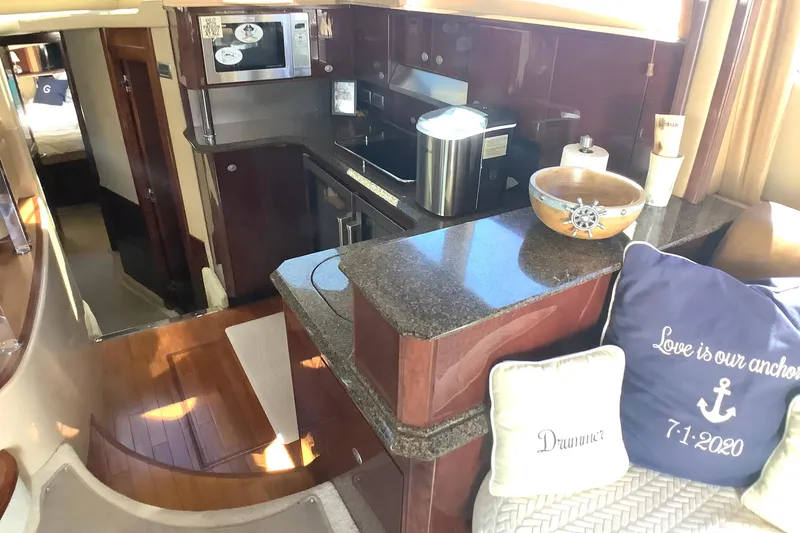 Slide: The Image of Luxurious interior of 2007 Sea Ray 52 Sedan Bridge yacht with modern kitchen amenities. - 31
