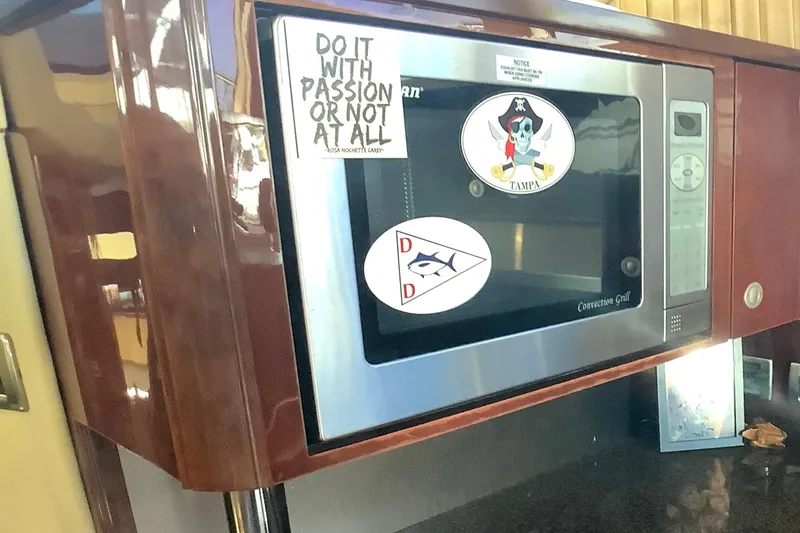Slide: The Image of Microwave in 2007 Sea Ray 52 Sedan Bridge with decorative stickers. - 33