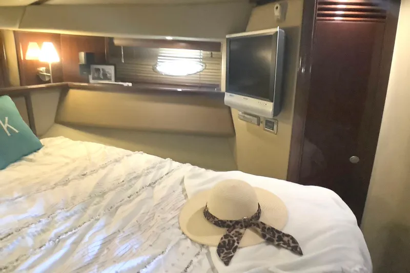 Slide: The Image of Luxurious 2007 Sea Ray 52 Sedan Bridge cabin with cozy bed and elegant decor. - 34