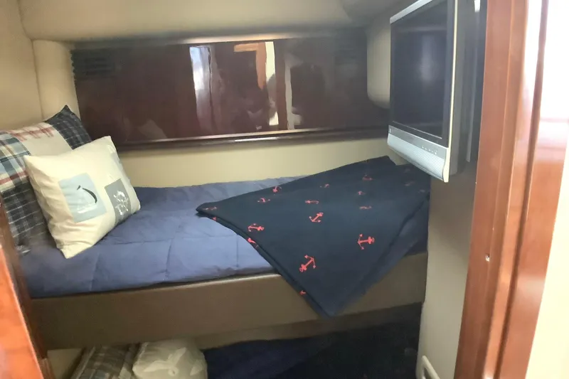 Slide: The Image of Cozy cabin interior of 2007 Sea Ray 52 Sedan Bridge with bed and TV. - 38