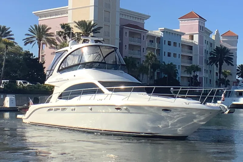 Slide: The Image of 2007 Sea Ray 52 Sedan Bridge yacht docked near waterfront buildings. - 4