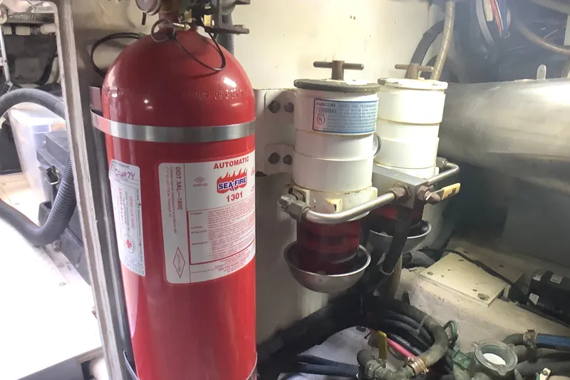 Slide: The Image of Engine room of 2007 Sea Ray 52 Sedan Bridge with fire extinguisher and fuel filters. - 45