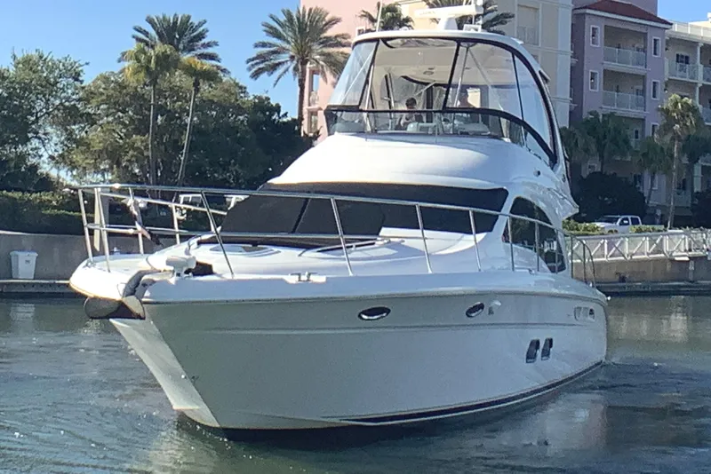 Slide: The Image of 2007 Sea Ray 52 Sedan Bridge yacht docked in a sunny marina setting. - 7