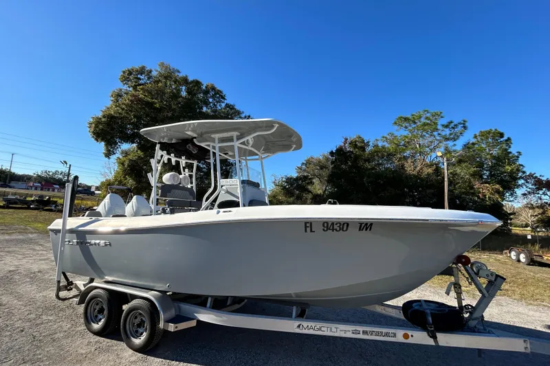 Slide: The Image of 2022 Clearwater 2300 boat on trailer, parked outdoors under clear blue sky. - 4