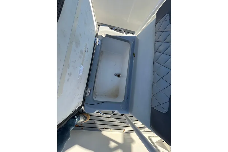 Slide: The Image of Open storage compartment on a 2022 Clearwater 2300 boat, featuring a clean interior. - 9