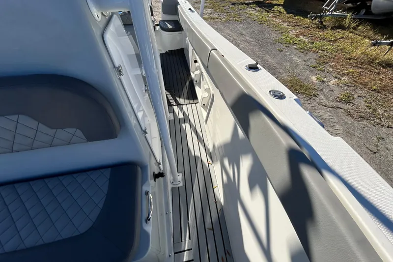 Slide: The Image of 2022 Clearwater 2300 boat interior with cushioned seating and sleek flooring. - 10