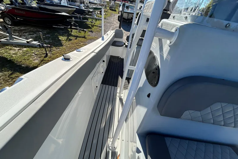 Slide: The Image of 2022 Clearwater 2300 boat interior with seating and deck view. - 11