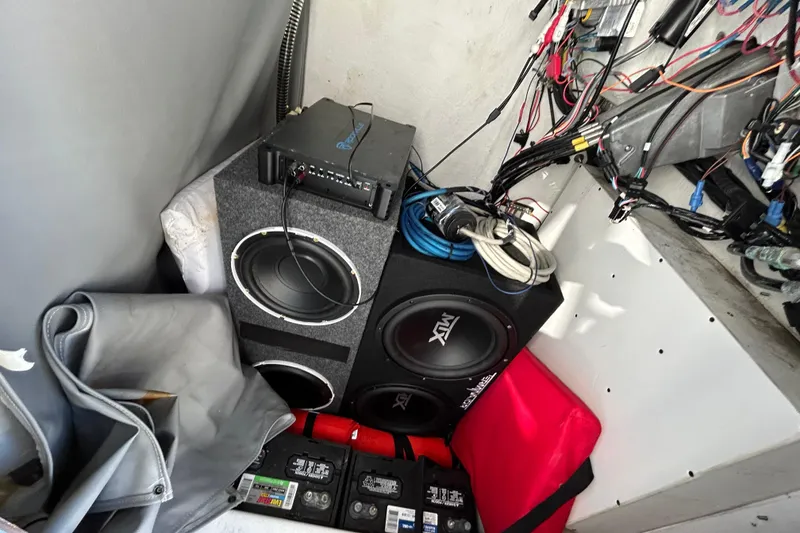 Slide: The Image of Audio equipment setup in a 2022 Clearwater 2300 boat, featuring speakers and wiring. - 18