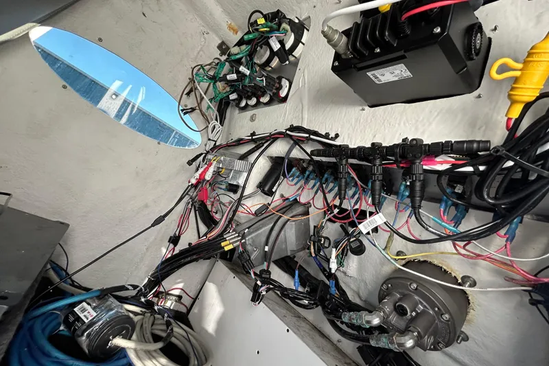 Slide: The Image of Interior wiring of a 2022 Clearwater 2300 boat, showcasing complex electrical systems. - 19