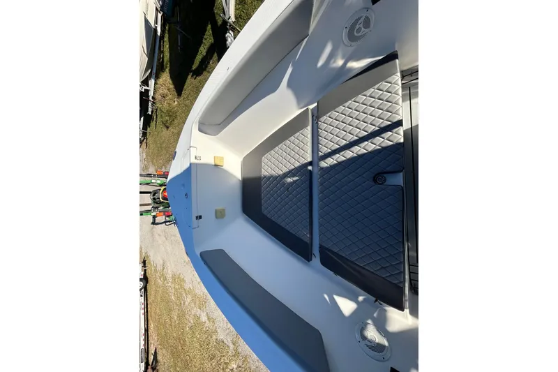 Slide: The Image of 2022 Clearwater 2300 boat interior with diamond-patterned seating and speaker. - 5