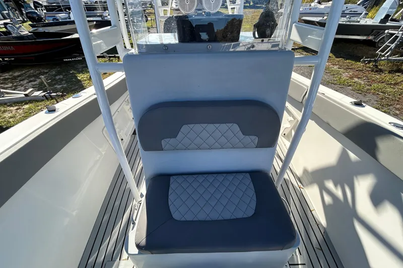 Slide: The Image of 2022 Clearwater 2300 boat interior with cushioned seating and console. - 7