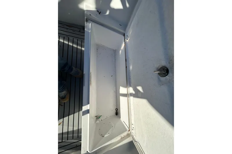 Slide: The Image of Open storage compartment on 2022 Clearwater 2300 boat deck. - 8