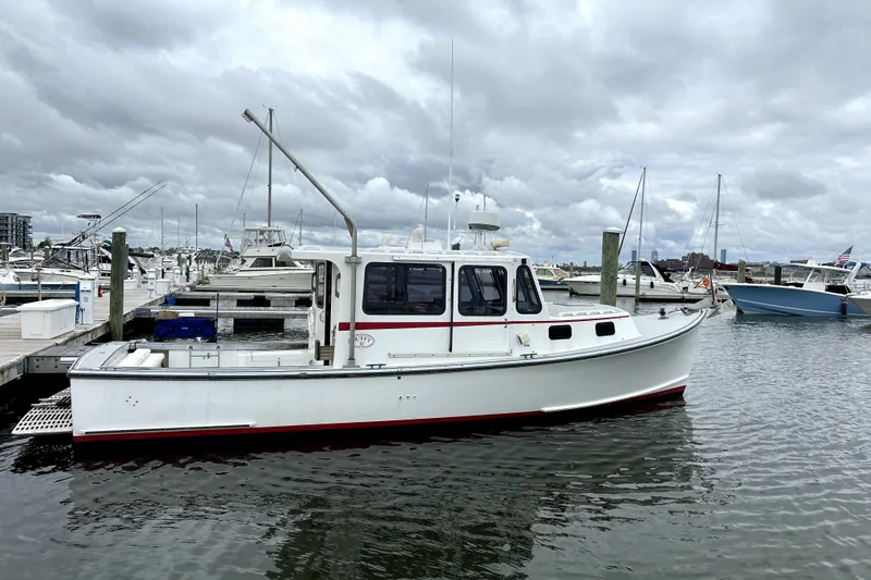 Slide: The Image of 1988 Duffy 31 Lobster Boat docked in a marina under cloudy skies. - 3