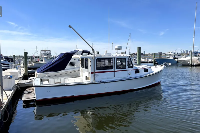 Slide: The Image of 1988 Duffy 31 Lobster Boat docked at marina under clear blue sky. - 5
