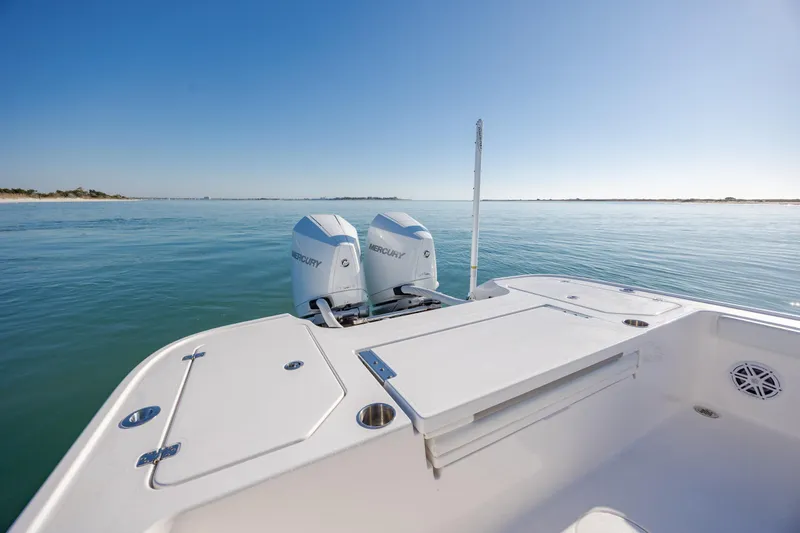 Slide: The Image of 2024 Caymas 281 HB boat with dual Mercury engines on calm water. - 11