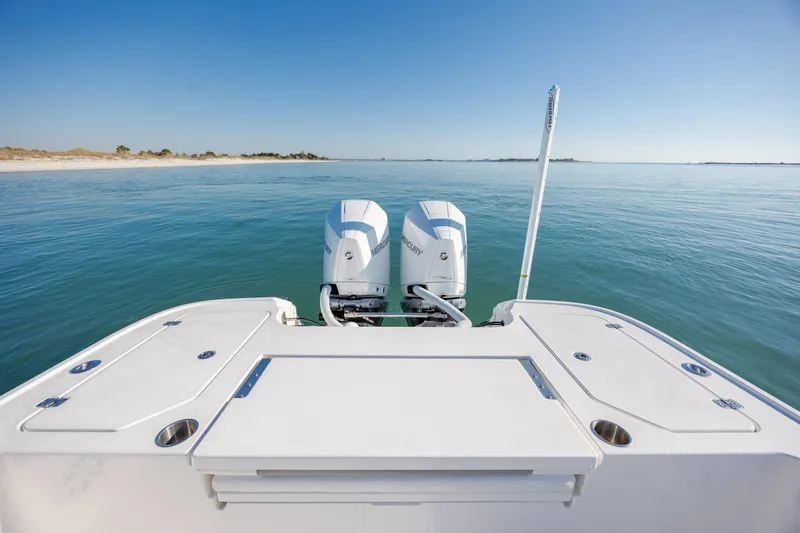 Slide: The Image of 2024 Caymas 281 HB boat with dual Mercury engines on calm water. - 12