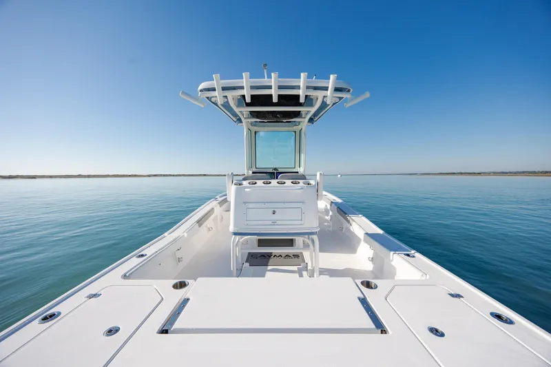 Slide: The Image of 2024 Caymas 281 HB boat on calm water under clear blue sky. - 14