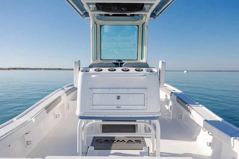 Slide: The Image of 2024 Caymas 281 HB boat on calm water, showcasing sleek design and spacious deck. - 15